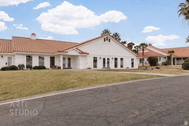 145 S Crystal Lakes Dr Unit 80, St George, UT 84770 - mediterranean / spanish-style home featuring french doors, a tile roof, a chimney, a front yard, and stucco siding