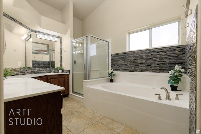 145 S Crystal Lakes Dr Unit 80, St George, UT 84770 - bathroom with vanity, a garden tub, a shower stall, decorative backsplash, and stone finish flooring