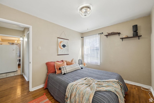 1240 E 520 S, Provo, UT 84606 - bedroom with freestanding refrigerator, a chandelier, baseboards, and wood finished floors