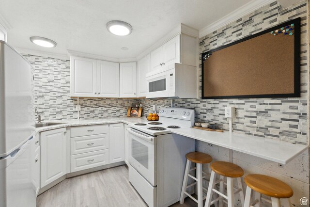 1240 E 520 S, Provo, UT 84606 - kitchen featuring white appliances, white cabinets, light countertops, decorative backsplash, and crown molding