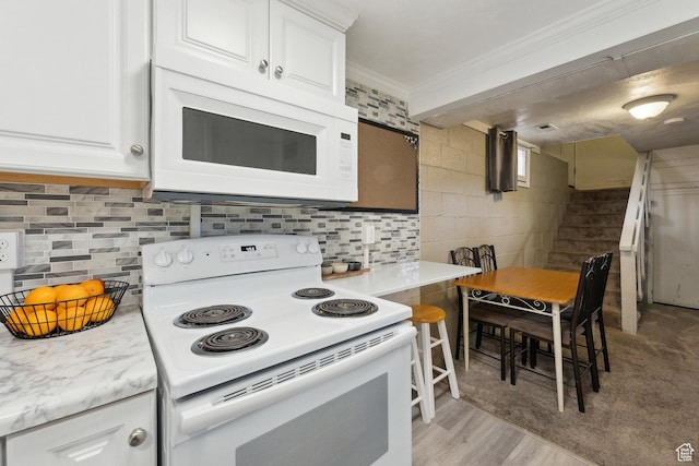 1240 E 520 S, Provo, UT 84606 - kitchen featuring white appliances, crown molding, white cabinets, decorative backsplash, and light wood-style flooring