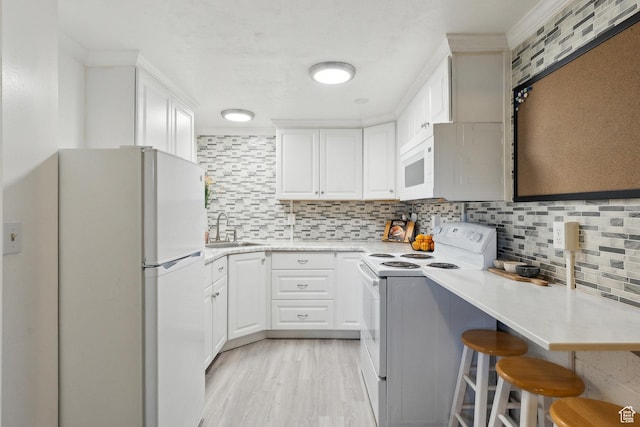 1240 E 520 S, Provo, UT 84606 - kitchen featuring white appliances, a sink, decorative backsplash, light countertops, and white cabinets