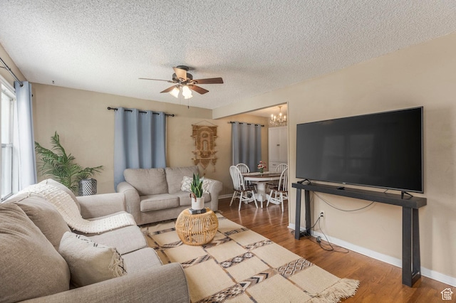 1240 E 520 S, Provo, UT 84606 - living area with a ceiling fan, wood finished floors, a textured ceiling, a chandelier, and baseboards