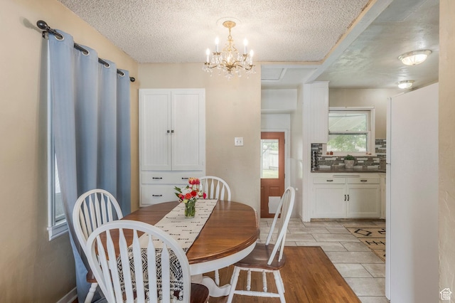 1240 E 520 S, Provo, UT 84606 - dining space with a textured ceiling, a chandelier, and light tile patterned flooring