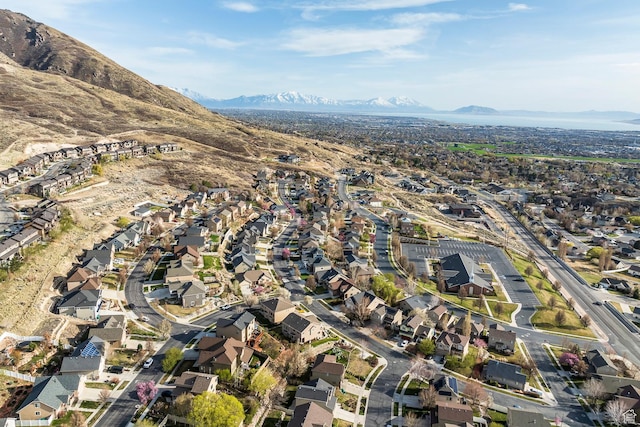 aerial overview of property's location with a mountainous background and nearby suburban area