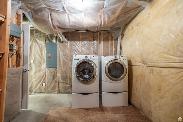 washroom featuring electric panel and washer and clothes dryer