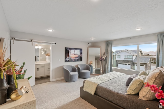 bedroom featuring baseboards, recessed lighting, connected bathroom, and carpet