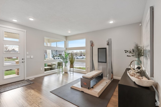 foyer entrance featuring recessed lighting, baseboards, and wood finished floors