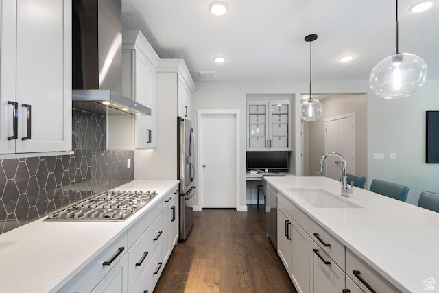 11779 S Windcroft Ct E, Sandy, UT 84092 - kitchen featuring a sink, wall chimney range hood, stainless steel appliances, decorative backsplash, and dark wood-style flooring