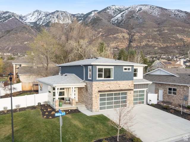 11779 S Windcroft Ct E, Sandy, UT 84092 - view of front of house with stone siding, a mountain view, a garage, and a porch