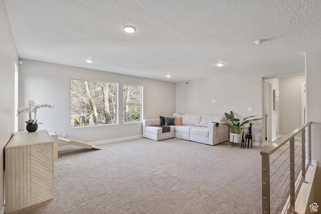 carpeted living area with a textured ceiling, baseboards, and recessed lighting