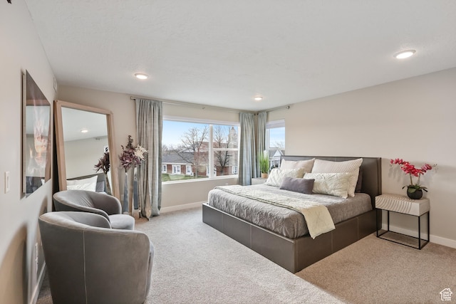 carpeted bedroom featuring recessed lighting and baseboards
