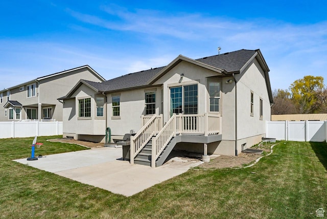 rear view of property with a yard, a patio, a fenced backyard, and stucco siding