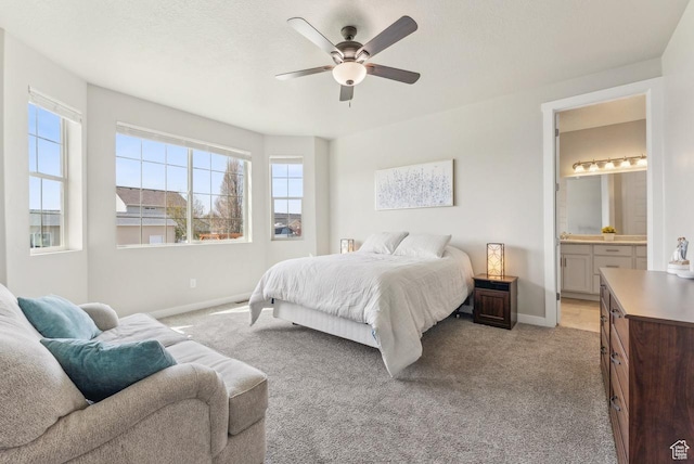 bedroom featuring light carpet, baseboards, and multiple windows