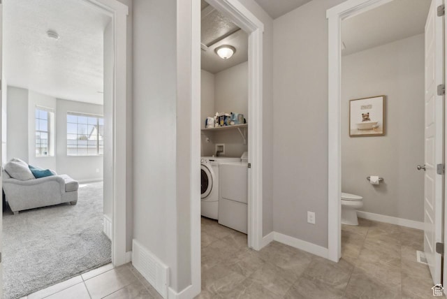 bathroom with visible vents, baseboards, washer and dryer, toilet, and tile patterned floors