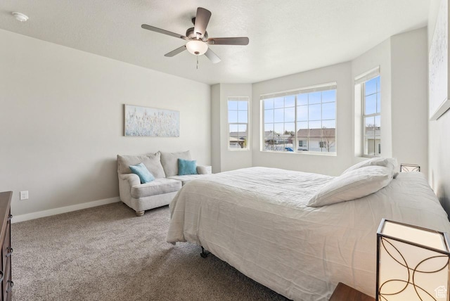 bedroom with carpet flooring, baseboards, a ceiling fan, and a textured ceiling
