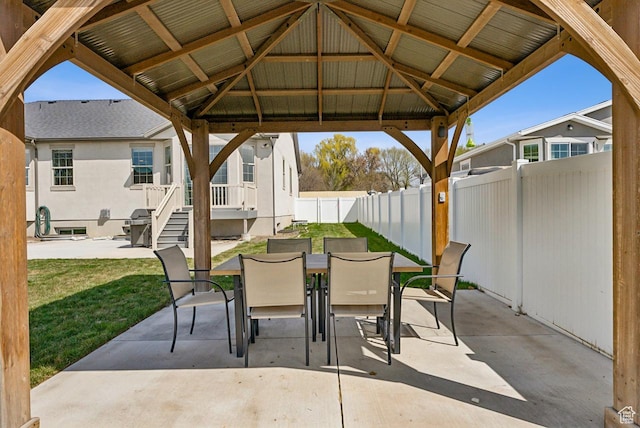 view of patio / terrace featuring a gazebo, outdoor dining area, and a fenced backyard