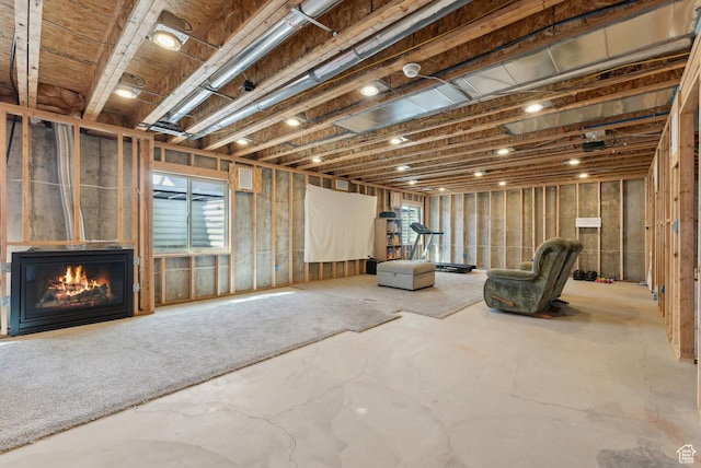 basement with a glass covered fireplace