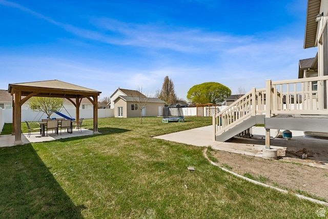 view of yard with a patio area, a fenced backyard, a gazebo, and a trampoline