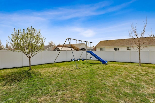 view of yard with a fenced backyard and a playground