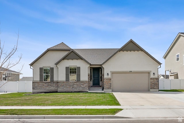 view of front facade featuring stucco siding, a front yard, fence, an attached garage, and driveway