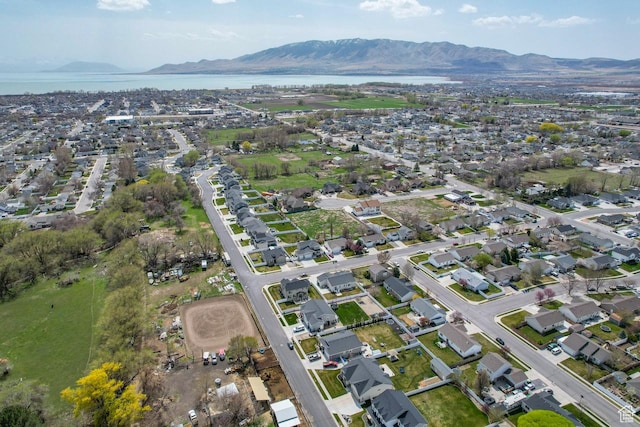 drone / aerial view featuring a water and mountain view