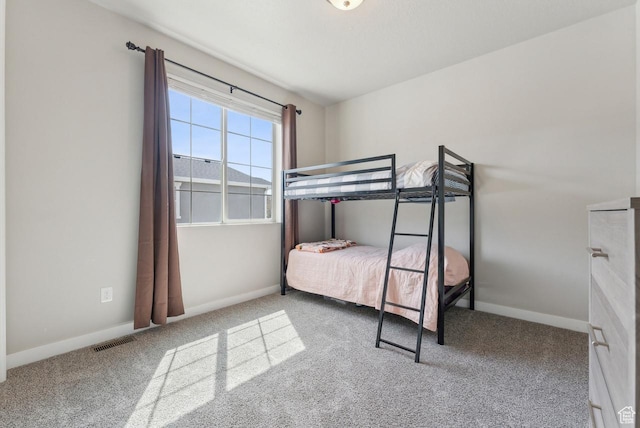 bedroom with baseboards, visible vents, and carpet floors