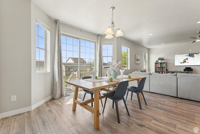 dining space with a notable chandelier, light wood-style flooring, and baseboards