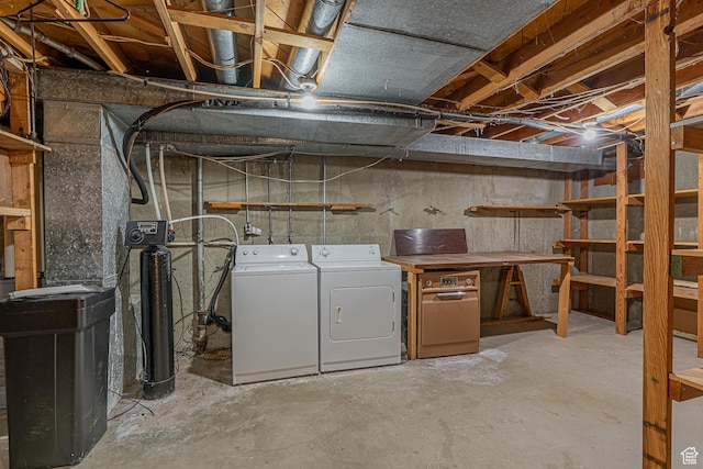unfinished basement with washer and clothes dryer