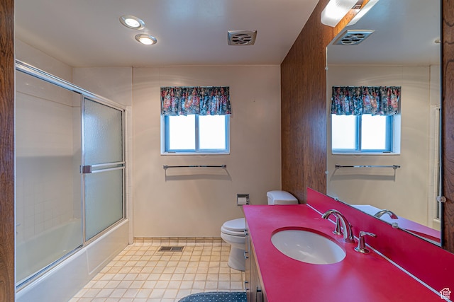 full bath featuring toilet, a healthy amount of sunlight, and visible vents