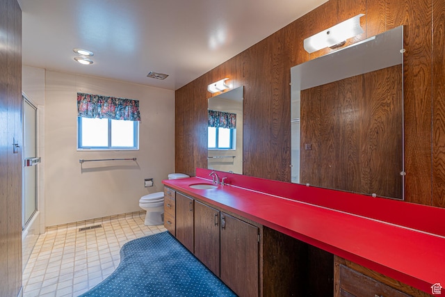 bathroom with vanity, visible vents, an enclosed shower, and toilet