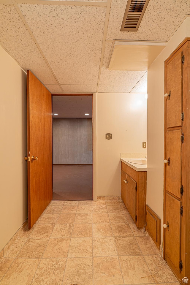 bathroom with vanity, a drop ceiling, and visible vents