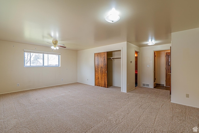 unfurnished bedroom with a closet, carpet, and visible vents
