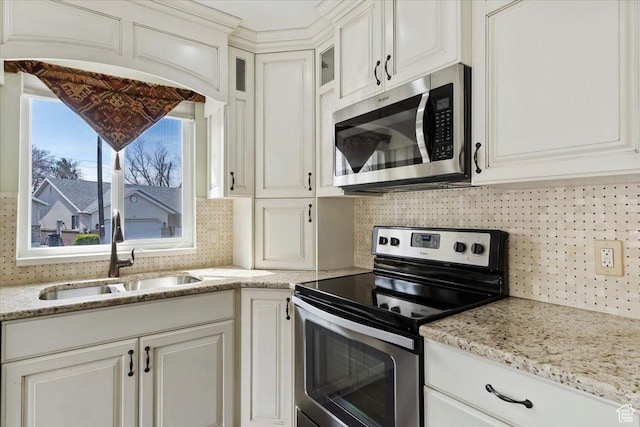 32 Belmore Dr, Kaysville, UT 84037 - kitchen featuring backsplash, a sink, glass insert cabinets, and stainless steel appliances
