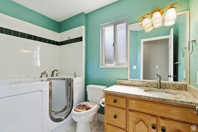 32 Belmore Dr, Kaysville, UT 84037 - bathroom featuring a bath, toilet, independent washer and dryer, vanity, and tile patterned floors