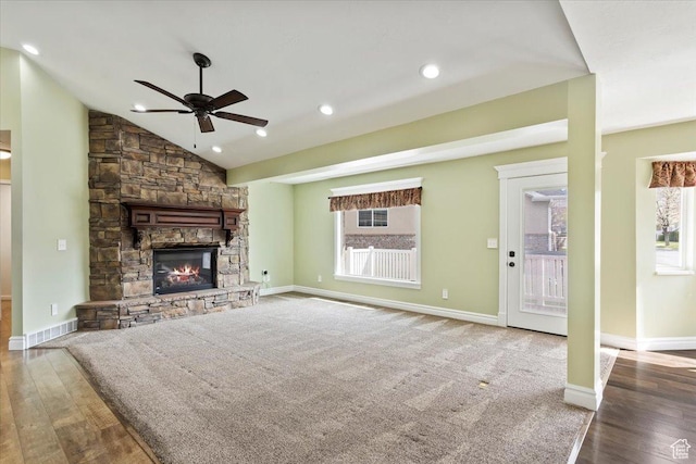 32 Belmore Dr, Kaysville, UT 84037 - unfurnished living room with baseboards, a stone fireplace, ceiling fan, wood finished floors, and vaulted ceiling