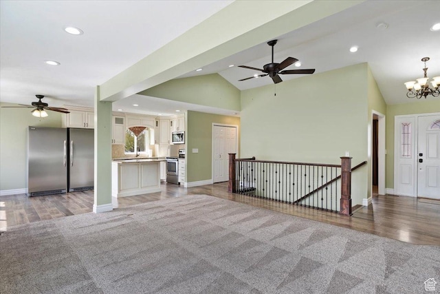 32 Belmore Dr, Kaysville, UT 84037 - unfurnished living room featuring light wood finished floors, lofted ceiling, recessed lighting, and ceiling fan with notable chandelier