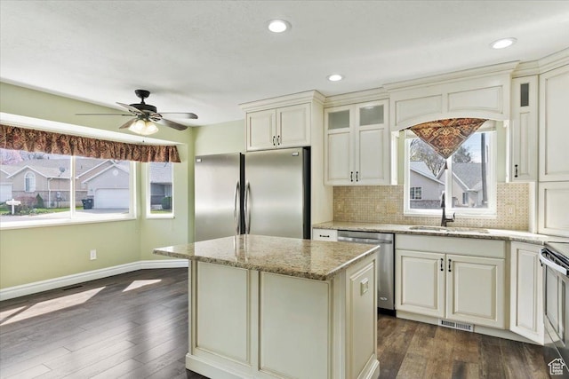 32 Belmore Dr, Kaysville, UT 84037 - kitchen featuring backsplash, cream cabinets, visible vents, appliances with stainless steel finishes, and a sink