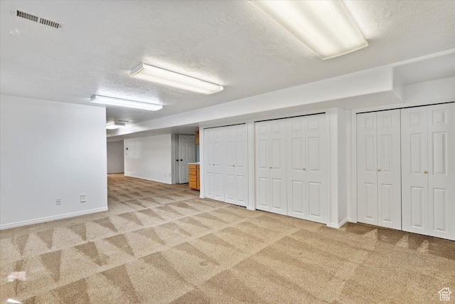 32 Belmore Dr, Kaysville, UT 84037 - finished below grade area featuring visible vents, baseboards, light carpet, and a textured ceiling