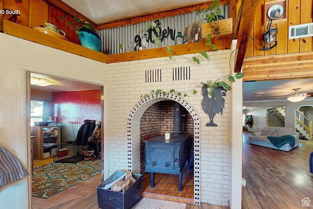 263 W 300 S, Parowan, UT 84761 - interior space featuring a ceiling fan, a wood stove, wood finished floors, and visible vents