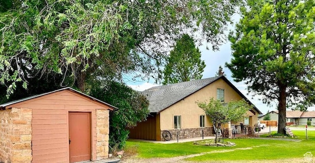 263 W 300 S, Parowan, UT 84761 - exterior space with stone siding, a lawn, a storage unit, roof with shingles, and stucco siding