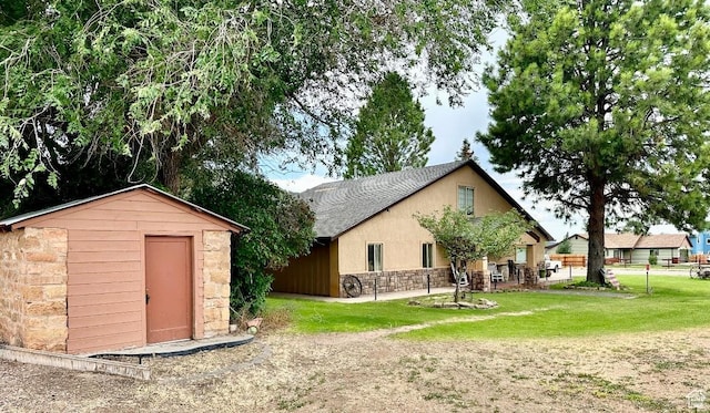 263 W 300 S, Parowan, UT 84761 - back of house with fence, stone siding, a shed, an outbuilding, and a lawn
