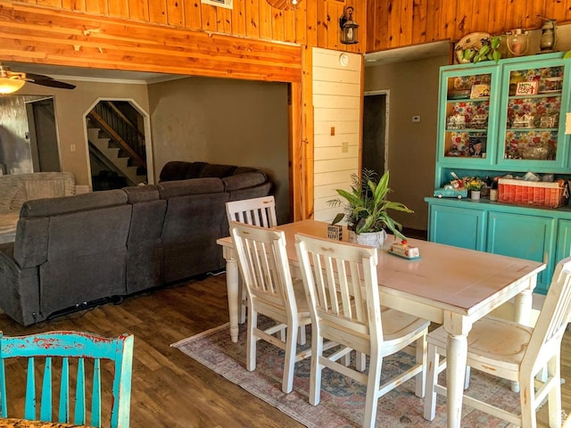 263 W 300 S, Parowan, UT 84761 - dining area featuring dark wood-style flooring, a ceiling fan, wooden walls, and stairs