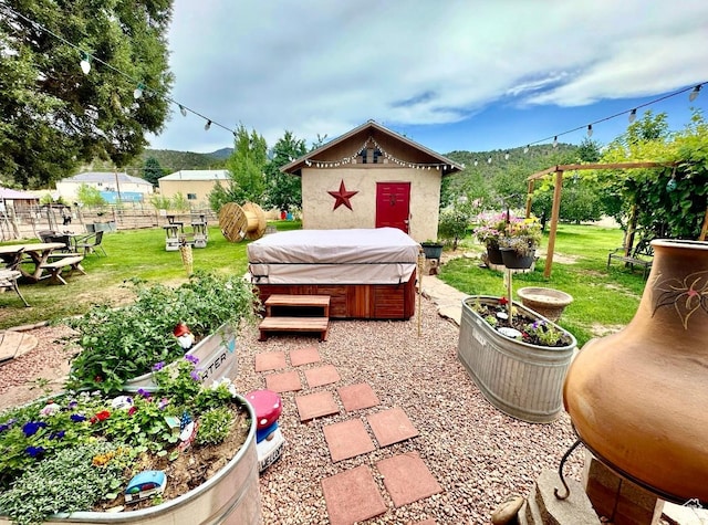 263 W 300 S, Parowan, UT 84761 - view of patio featuring a hot tub, fence, and a mountain view