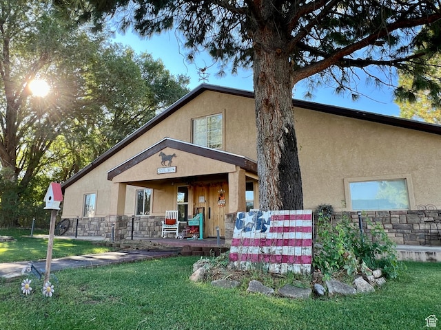 263 W 300 S, Parowan, UT 84761 - rear view of house with a lawn, a porch, stone siding, and stucco siding