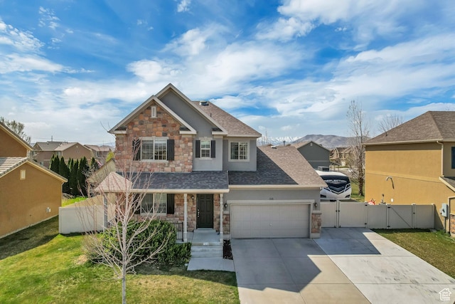 craftsman-style house with an attached garage, driveway, stone siding, and a gate