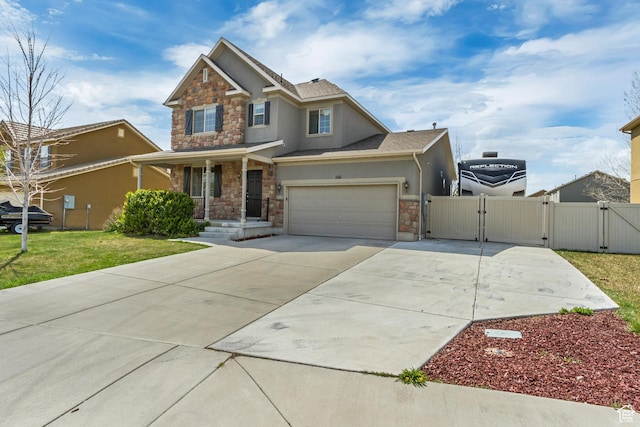 craftsman-style house featuring driveway, stucco siding, stone siding, and a gate