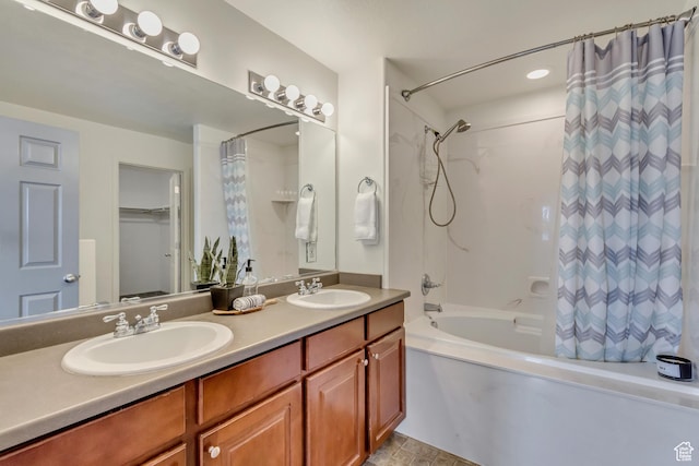 full bath featuring a sink, shower / bath combo with shower curtain, and double vanity