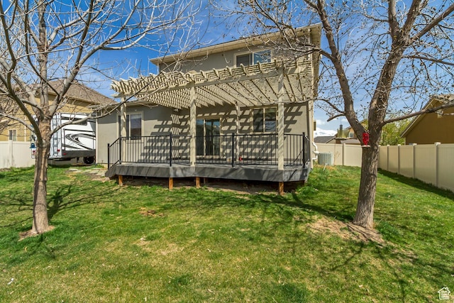 back of house with a fenced backyard, stucco siding, a wooden deck, and a pergola