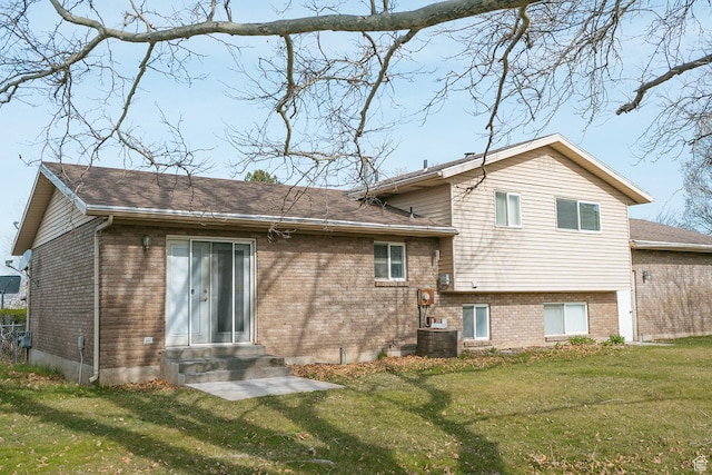 20 E 9n Cir N, American Fork, UT 84003 - back of house featuring entry steps, brick siding, a yard, and central air condition unit